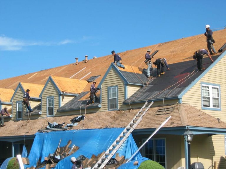 our team member work on roof together